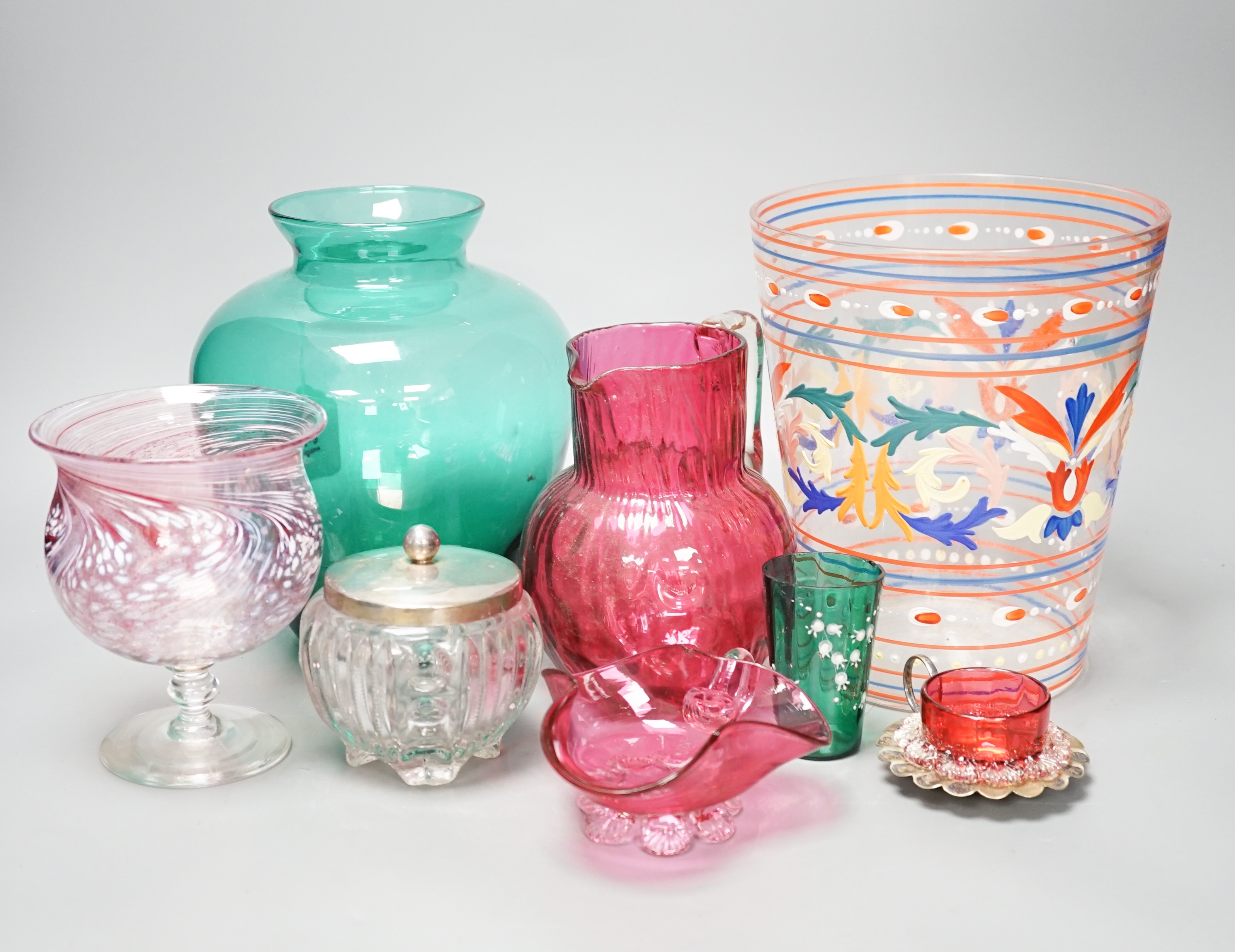 A collection of cranberry glass, a silver lidded glass sugar bowl, and enamelled glass historismus humpen etc